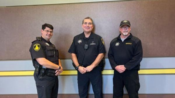 Three male officers of the Black Hawk Police Department pose for a picture together.